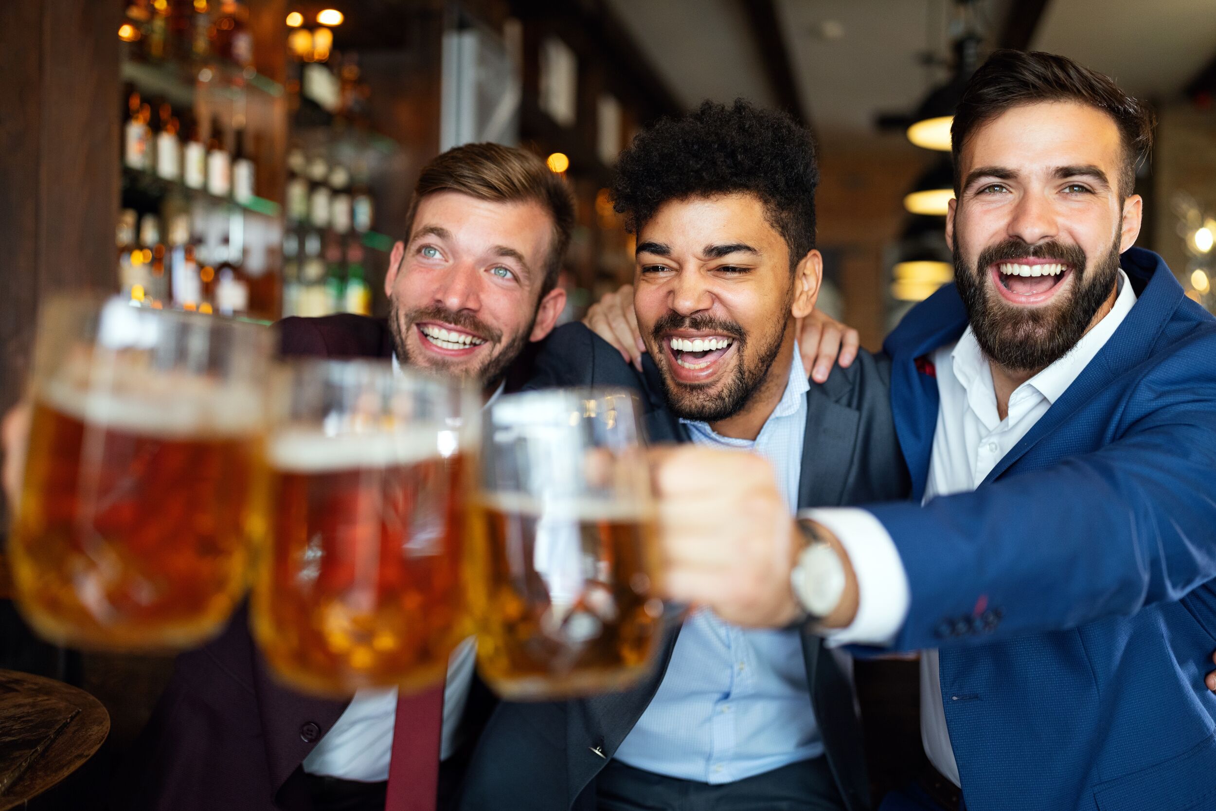 Bachelor Party Pub Crawl - Group of men friends at the pub watching football game and drinking beer