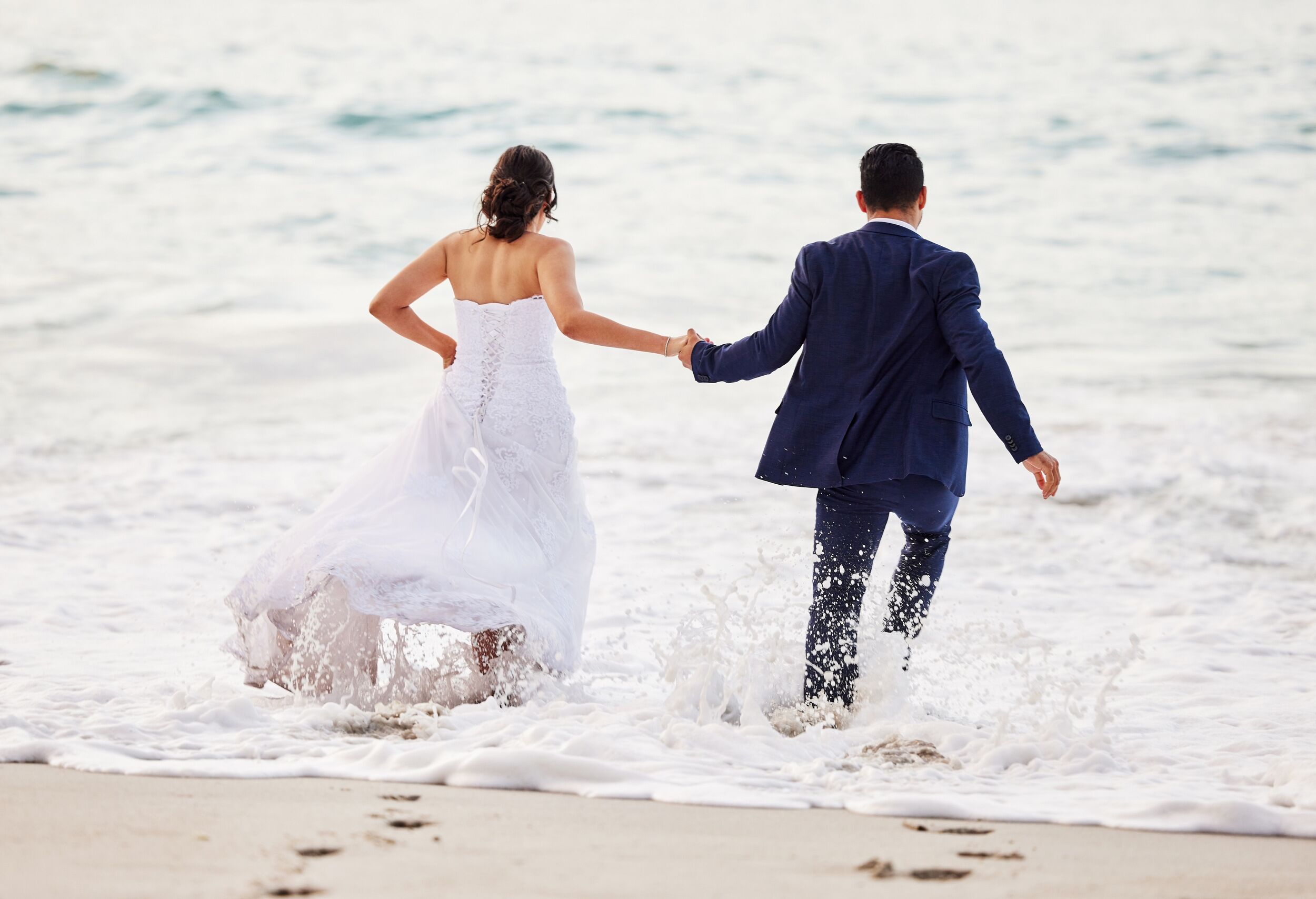 Shot of a young couple on the beach on their wedding day.
