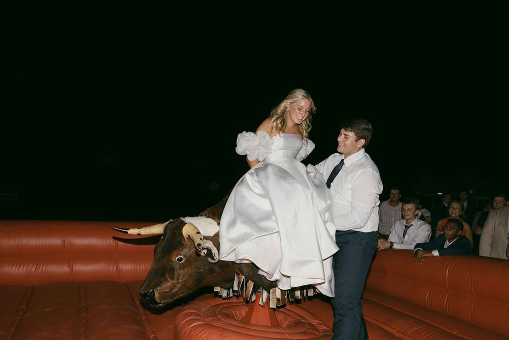 Buck Wild Bride and Groom on Bull - Mary Bender Photography - Mechanical Bull Riding Rental Wedding Vendor