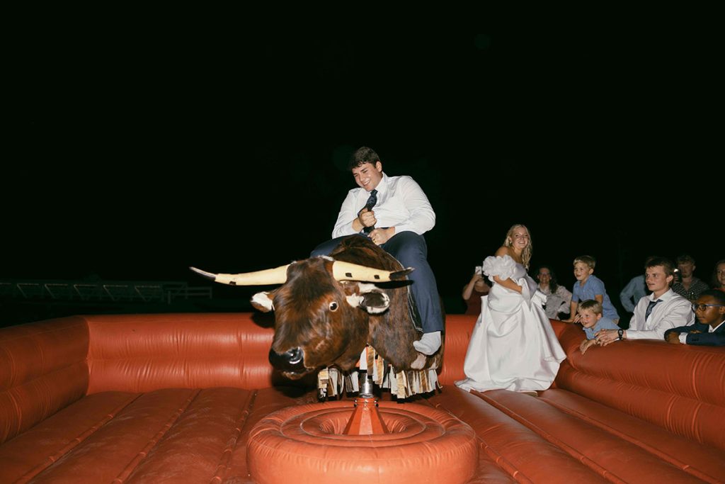 Buck Wild Groom Riding Bull - Mary Bender Photography - Mechanical Bull Riding Rental Wedding Vendor