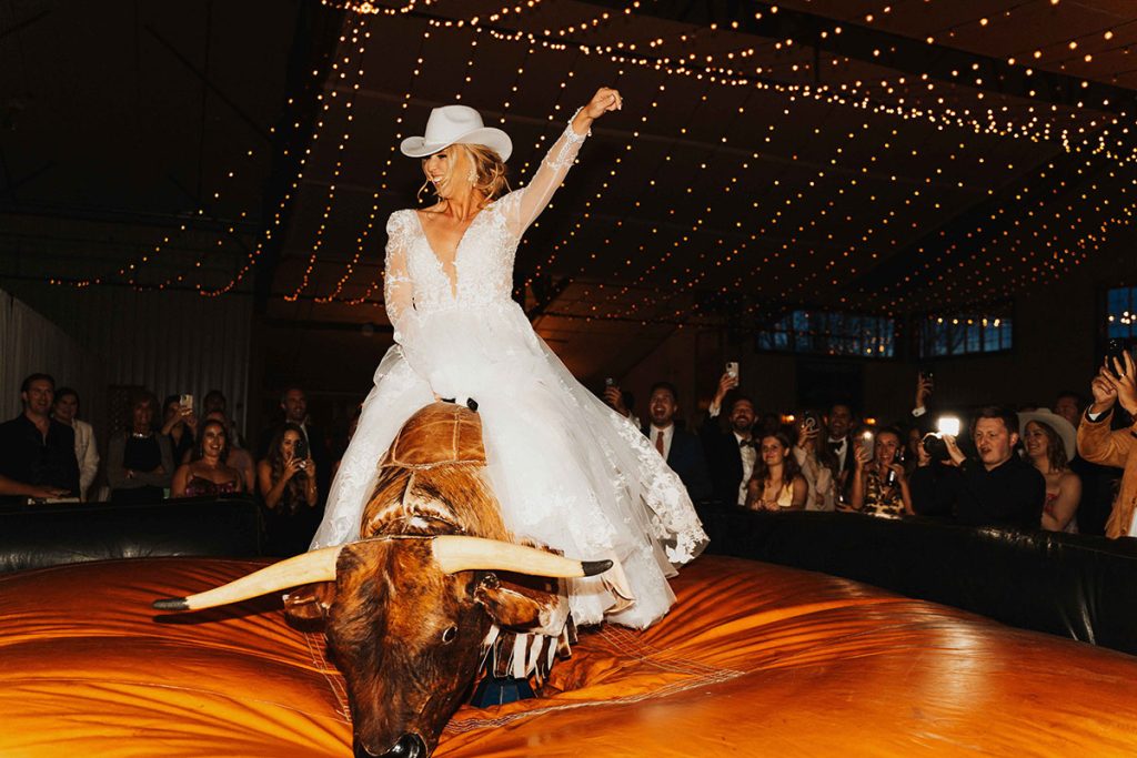 Western Wedding Bride on Buck Wild Bull - Sarah Penny Photography - Bull Riding Mechanical Bull Wedding Vendor