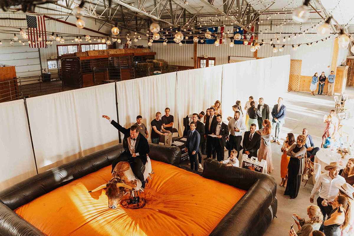 Buck Wild 14 - Sarah Penny Photography - Bull Riding Mechanical Bull Rental Wedding Vendor Buck Wild Groom on Bull - Sarah Penny Photography - Bull Riding Mechanical Bull Rental Wedding Vendor