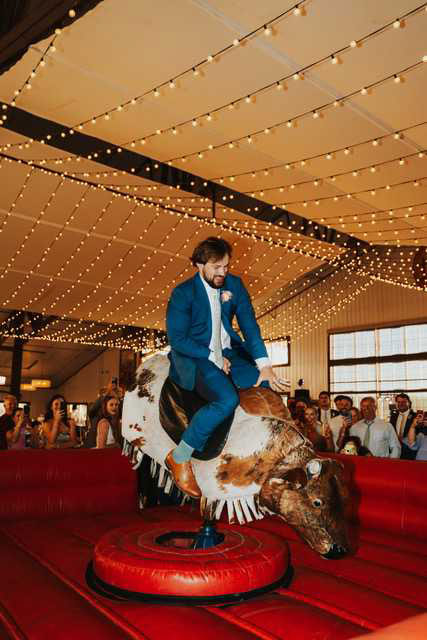 Buck Wild Groom on Bull - Sarah Penny Photography - Bull Riding Mechanical Bull Wedding Vendor